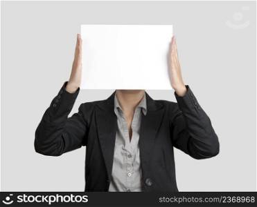 Woman showing a blank paper sheet in front of her head 