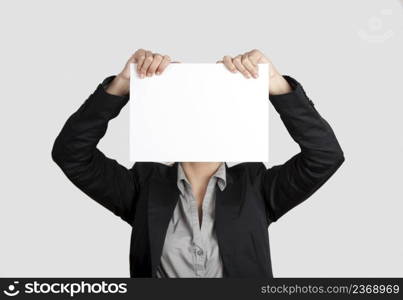 Woman showing a blank paper sheet in front of her head 