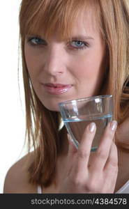 Woman showing a glass of water