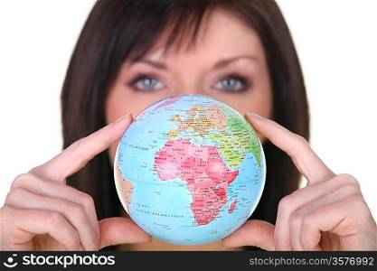 Woman showing a globe