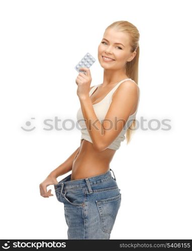woman showing big pants and pack of pills