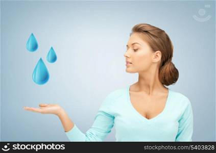 woman showing blue water drops on her hand