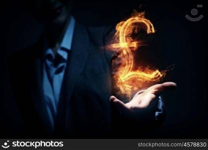 Woman showing dollar symbol. Burning pound sign in businesswoman palm on dark background