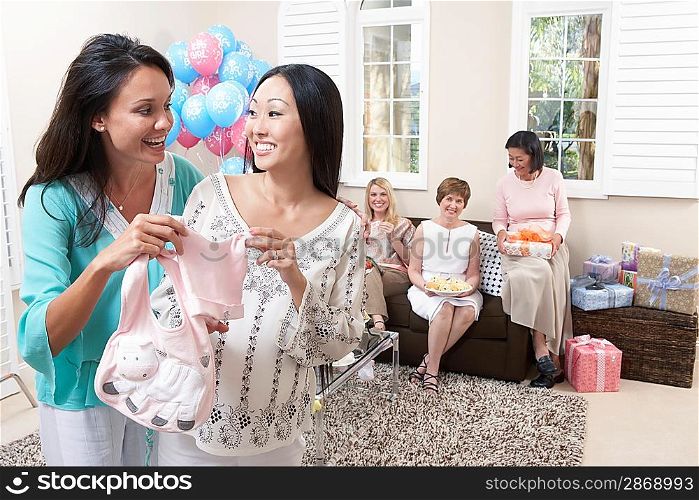 Woman showing gift at baby shower