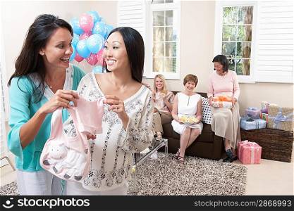 Woman showing gift at baby shower