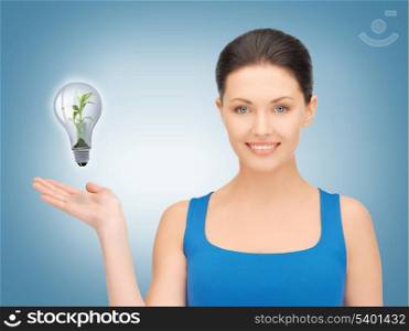 woman showing green light bulb on her hand