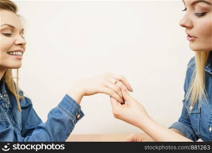 Woman showing her happy shocked female friend engagement ring sharing great news.. Woman showing her friend wedding ring