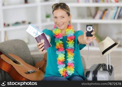 woman showing her passport ticket and digital camera