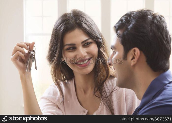Woman showing keys to her husband