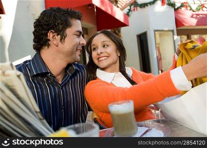 Woman Showing Man Her Purchase