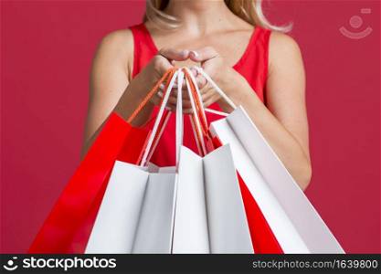 woman showing off lots shopping bags after shopping spree