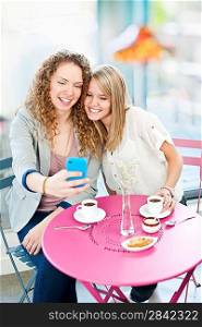 Woman showing phone to friend