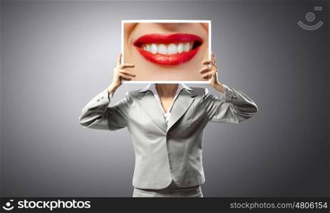 Woman showing photo. Unrecognizable businesswoman holding big photo with lips