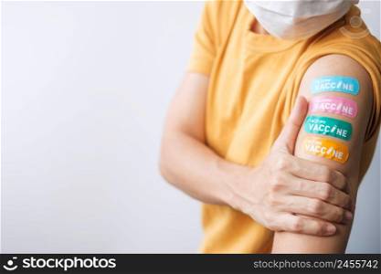 woman showing plaster after receiving covid 19 vaccine. Vaccination, herd immunity, side effect, booster dose, vaccine passport and Coronavirus pandemic