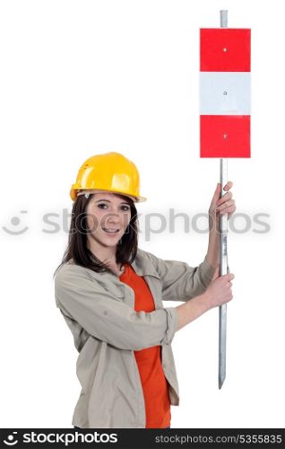 Woman showing road sign