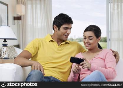 Woman showing something interesting in mobile phone