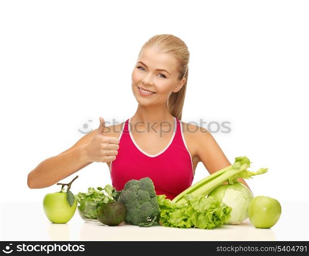 woman showing thumbs up with fruits and vegetables