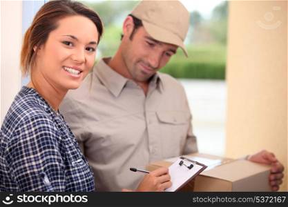 Woman signing for a package