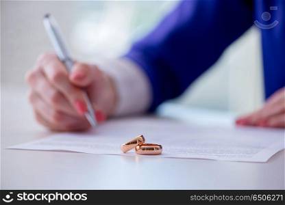 Woman signing prenuptial agreement in court