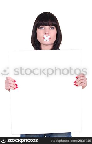 Woman silently holding message board