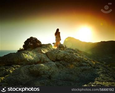 Woman silhouette at sunset in mountains. Crimea landscape