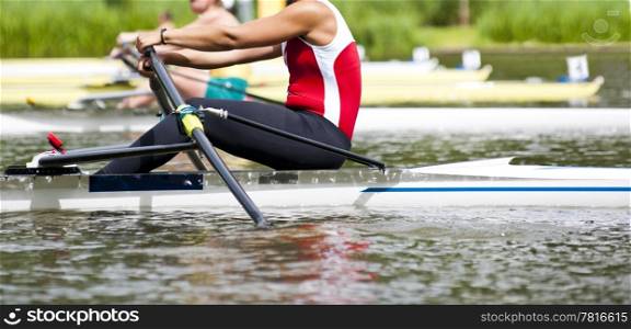 Woman Single sculls rower during the start of a rowing regatta