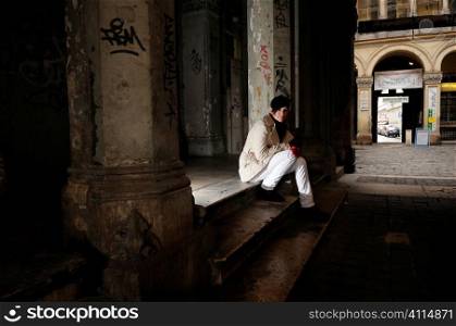 Woman sits in doorway, Budapest, Hungary