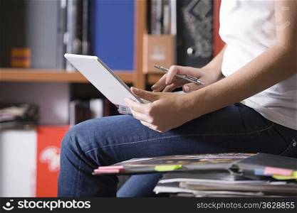 Woman sits working on desk working on laptop