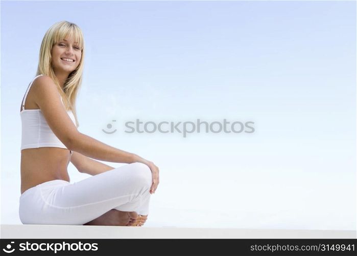 Woman sitting and meditating outdoors