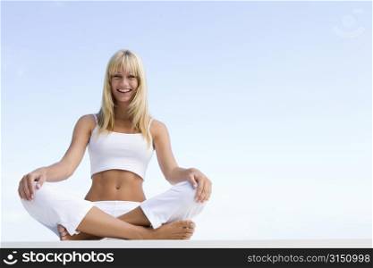 Woman sitting and meditating outdoors