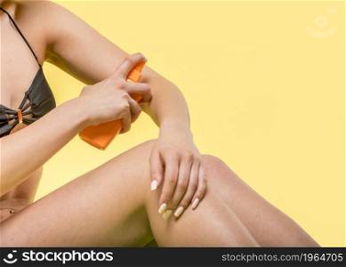 woman sitting applying sunscreen skin. High resolution photo. woman sitting applying sunscreen skin. High quality photo