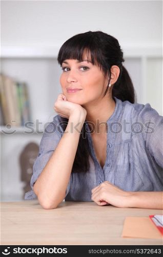 Woman sitting at a kitchen table