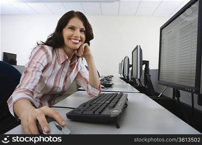 Woman sitting at desk in front of computer