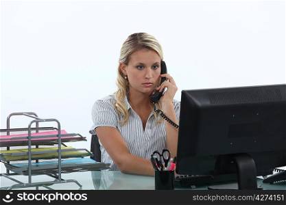 Woman sitting at her desk on the phone
