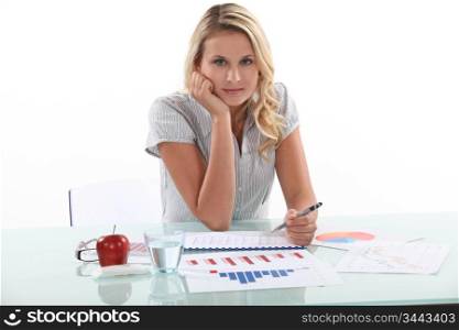 Woman sitting at her desk with statistics