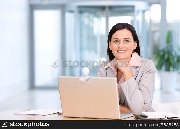 woman sitting at laptop in office