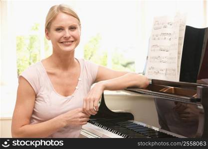 Woman sitting at piano and smiling