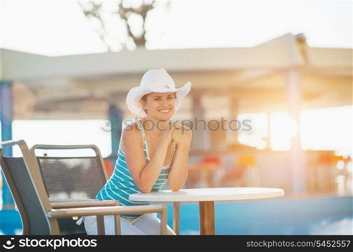 Woman sitting at pool bar