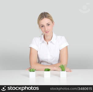 Woman sitting by plants set on table