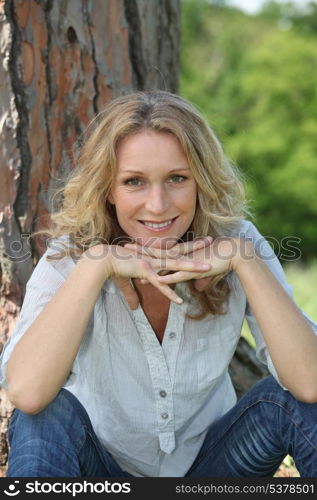 woman sitting by tree