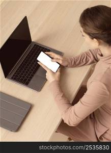 woman sitting her laptop using smartphone 2