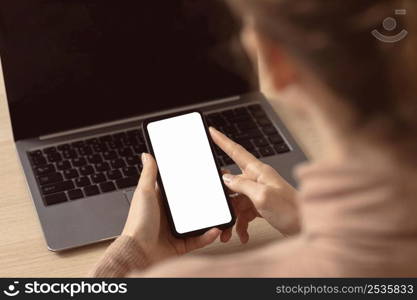 woman sitting her laptop using smartphone