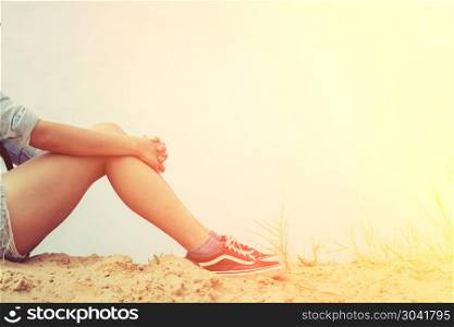 Woman sitting hugging knees with grief.