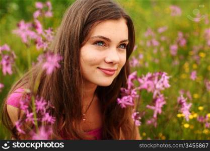 Woman sitting in a field of flowers