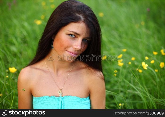 Woman sitting in a field of flowers