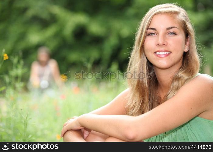Woman sitting in a meadow