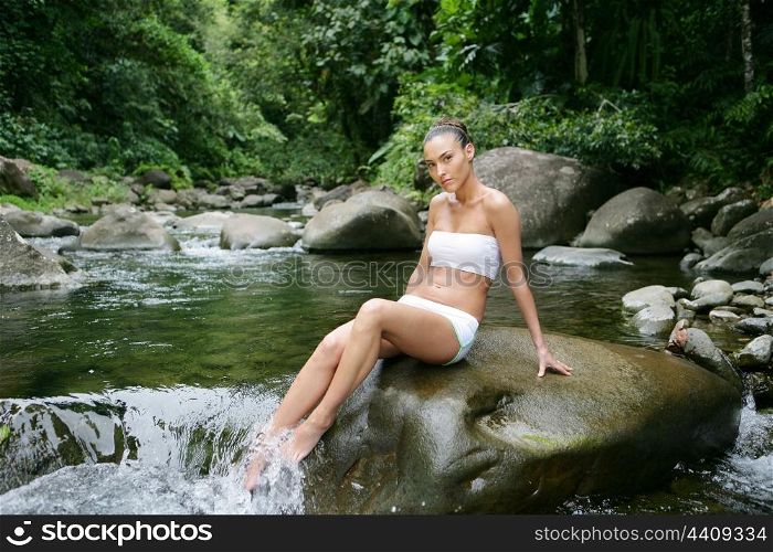 Woman sitting in a river