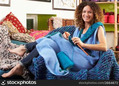 Woman Sitting In Chair Knitting