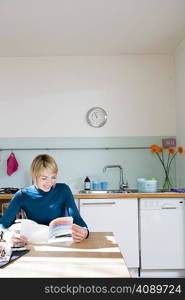 Woman sitting in kitchen