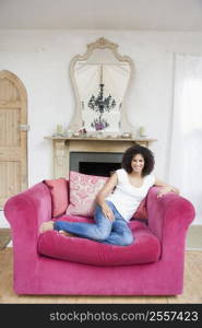 Woman sitting in living room smiling